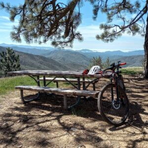 mountain bike leaning on picnic table